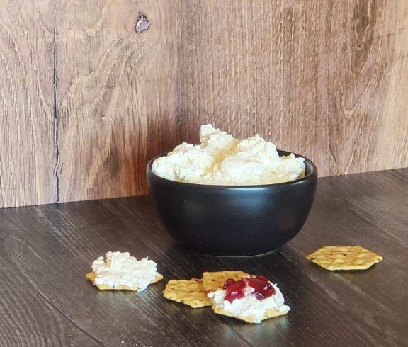 Chevre - fresh goat cheese spread on a cracker with jelly